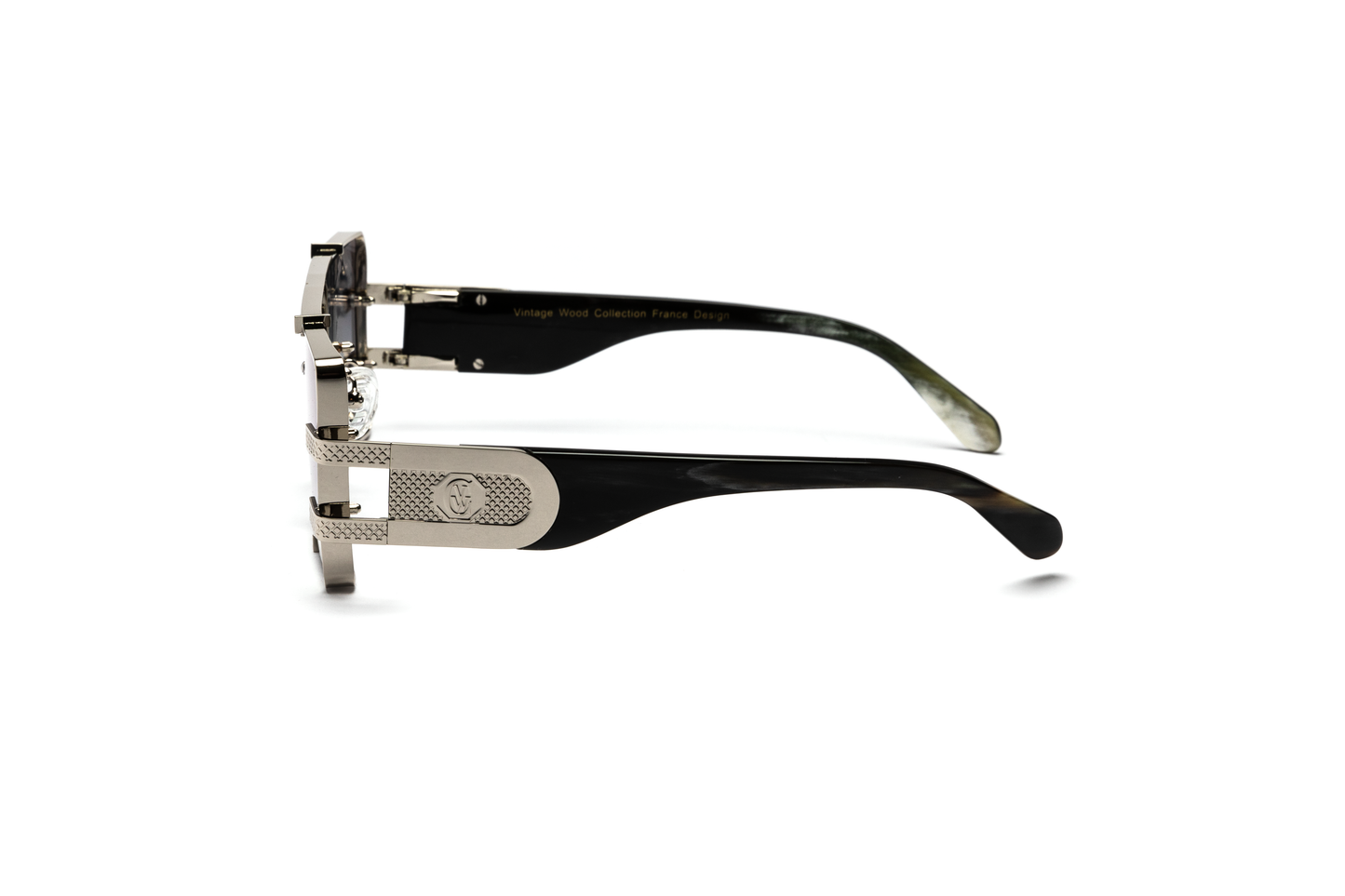Side-angle product image of black and silver buffalo horn sunglasses from Vintage Wood Collection, featuring sleek metal detailing and gradient grey lenses. The sunglasses have a modern, street-style design and are displayed on a clean white background.