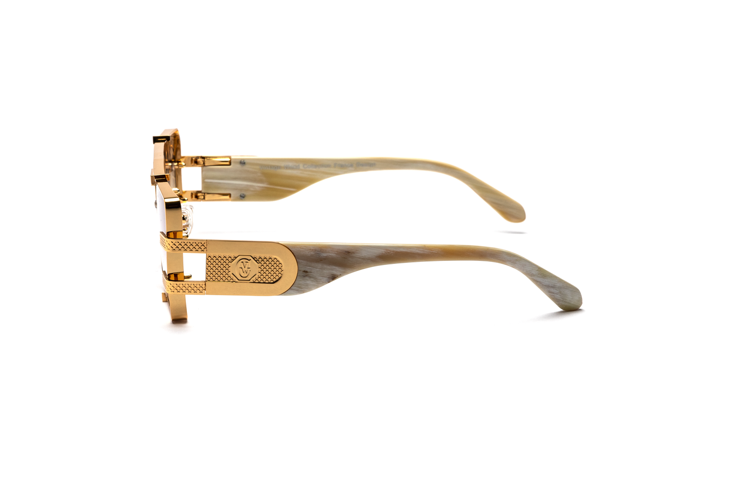 Side view of the Pinnacle Frame sunglasses highlighting the white buffalo horn frame, 24-carat gold detailing, and brown gradient lenses, displayed on a white background.