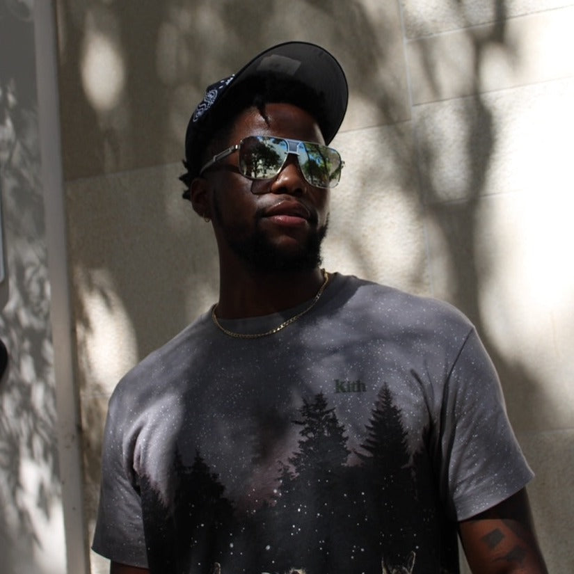 Model wearing the Brigade grey and silver wood sunglasses by Vintage Wood Collection in the Design District mIami