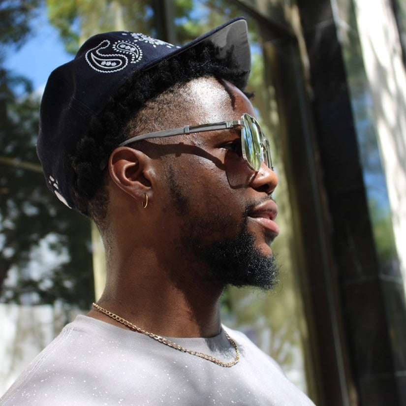 Model wearing the Brigade grey and silver wood sunglasses by Vintage Wood Collection in the Design District mIami