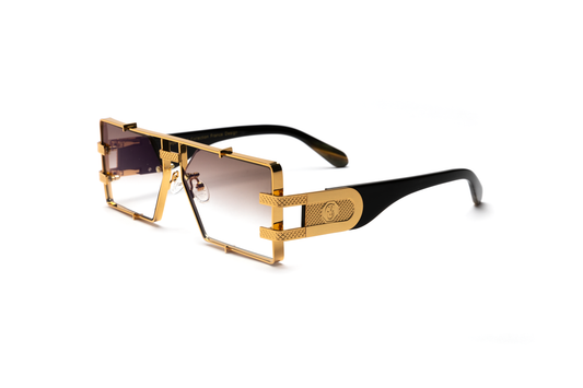 Side-angle product image of black buffalo horn sunglasses from Vintage Wood Collection, featuring 24-karat gold detailing and gradient brown lenses. The sunglasses have a sleek, street-style design and are displayed on a clean white background.