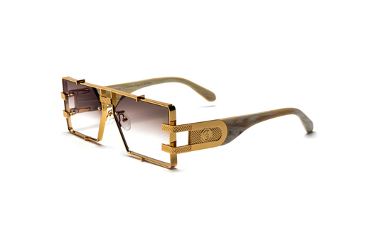 Side view of the Pinnacle Frame sunglasses highlighting the white buffalo horn frame, 24-carat gold detailing, and brown gradient lenses, displayed on a white background.